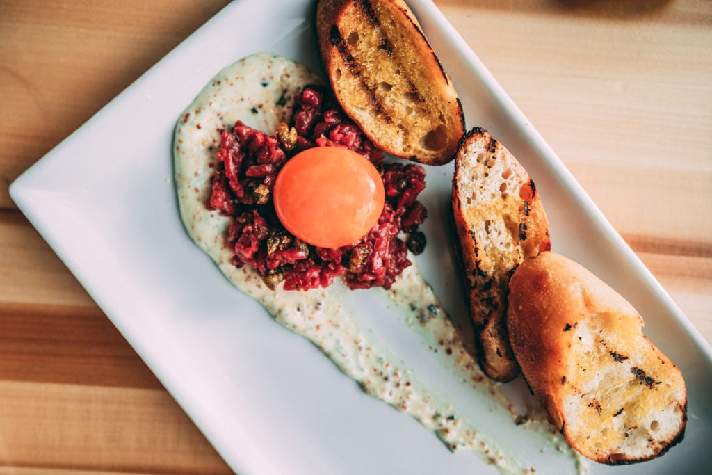 Sky Bistro Banff: Alberta Bison Tartar - Pickled Egg Yolk, Remoulade, Capers, Cold Pressed Alberta Canola Oil, Char Bread